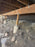 Burrowing rodent barrier mesh installed under a raised deck around pier footings

