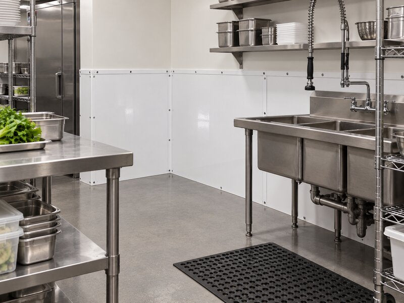 White FRP wall panels installed behind a triple-compartment sink station
