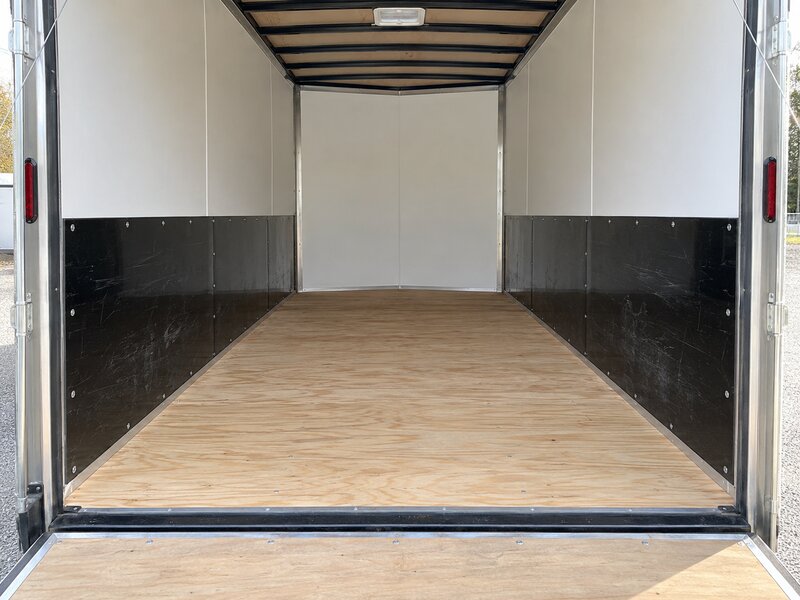 Enclosed cargo trailer interior with black HDPE wall liner installed on the lower walls
