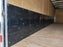 Close-up of HDPE wall liner panel installed near a cargo trailer side door
