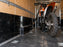 Dirt bike strapped down inside a cargo trailer lined with black HDPE wall panels
