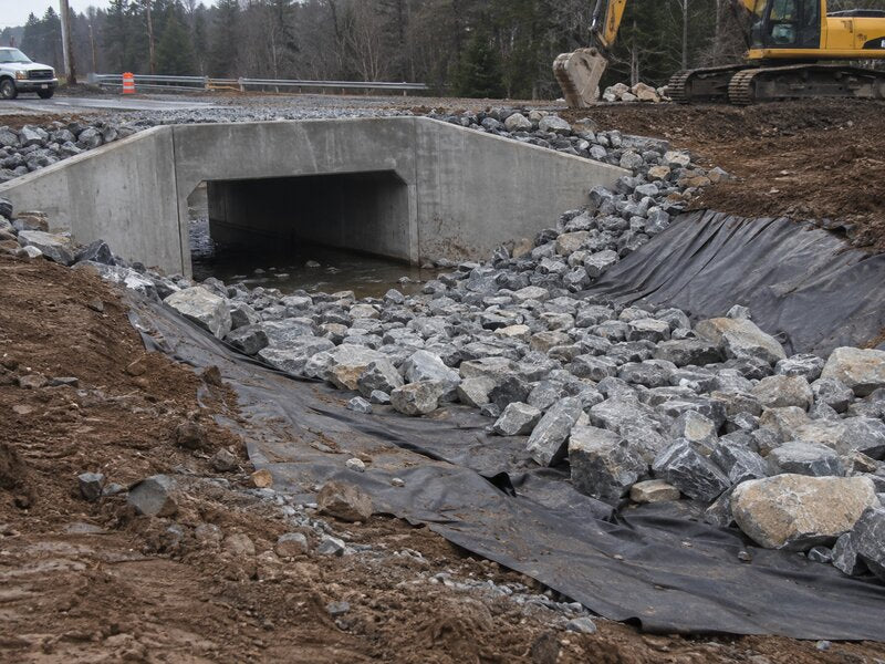 Non-woven geotextile fabric placed beneath riprap stone at a culvert outlet

