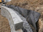 Non-woven geotextile fabric wrapping drainage gravel behind a block retaining wall

