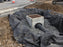 Non-woven geotextile fabric lining a storm drain inlet excavation with gravel
