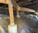 Wire mesh rodent barrier installed under a structure around a pier
