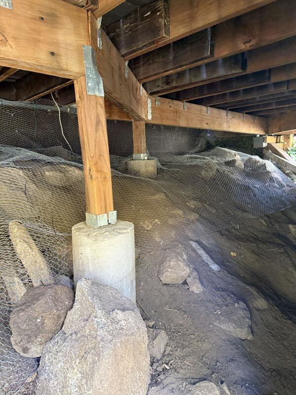 Rodent exclusion mesh wrapped around crawl space pier footings
