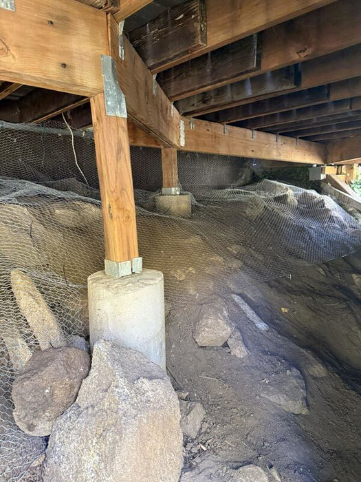 Rodent exclusion mesh wrapped around crawl space pier footings

