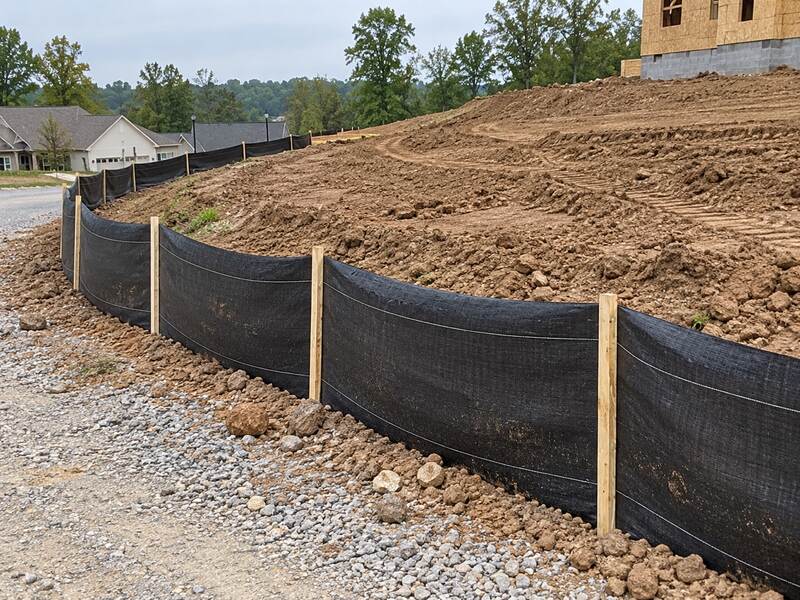 Silt fence lining a gravel road at a home construction site in a new subdivision
