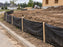 Silt fence installed along a curb at a new home construction site in a residential subdivision
