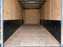 Empty cargo trailer interior with bare plywood walls before HDPE wall liner installation
