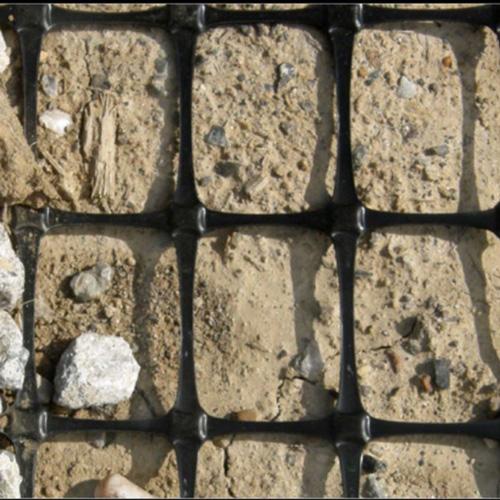 GBX-12 Biaxial Geogrid on the ground with dirt and rocks